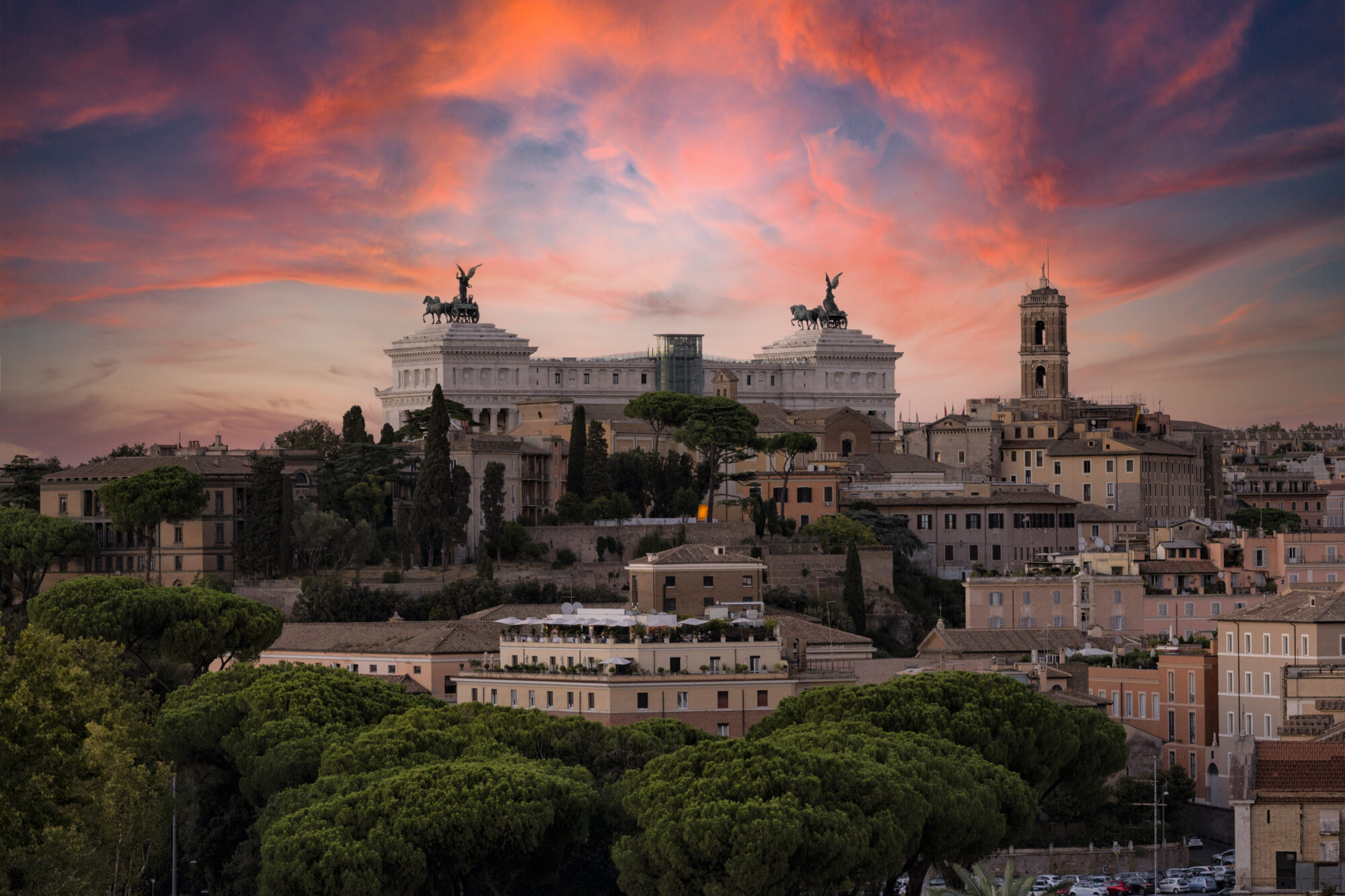 Panoramic sunset view of Victor Emmanuel II Monument or Vittoriano, Altare della Patria from the Orange Garden (Giardino degli Aranci) on the aventine hill in Rome, Italy Panoramic sunset view of Victor Emmanuel II Monument or Vittoriano, Altare della Patria from the Orange Garden (Giardino degli Aranci) on the aventine hill in Rome, Italy