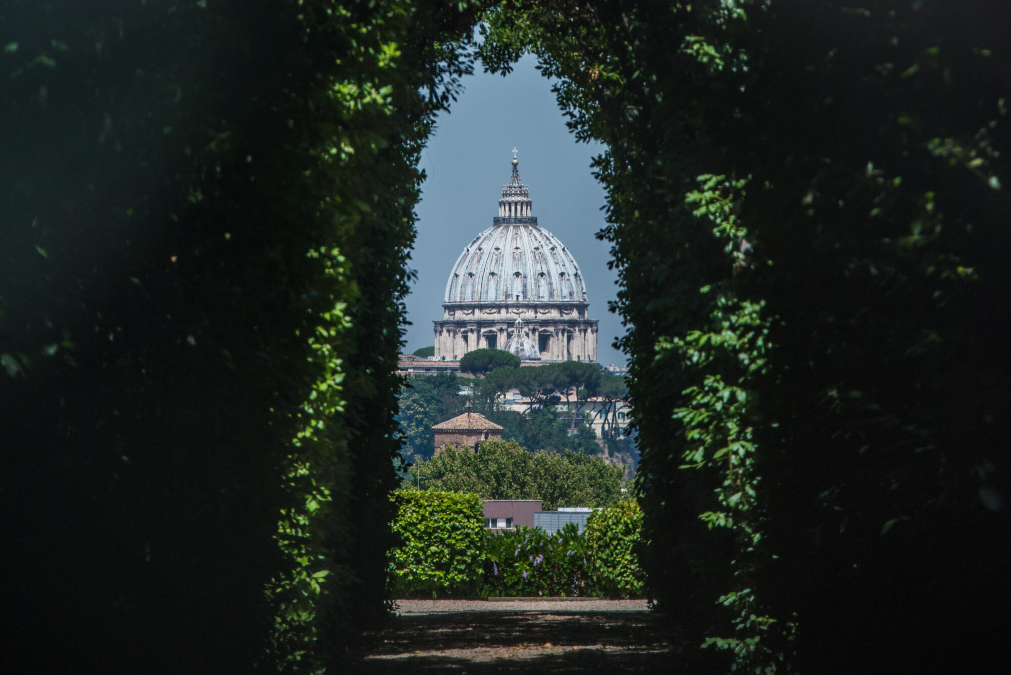 The dome of Saint Peters Basilica seen through the famous keyhole at the the gate of the Priory of the Knights of Malta on Aventino Hill. Rome, Italy, Southern Europe The dome of Saint Peters Basilica seen through the famous keyhole at the the gate of the Priory of the Knights of Malta on Aventino Hill. Rome, Italy, Southern Europe