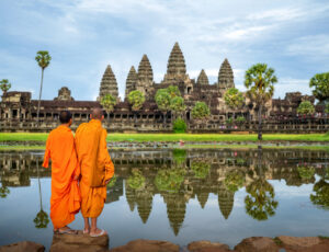 Asian monk stand and look to Angkor wat in siem reap Asian monk stand and look to Angkor wat in siem reap