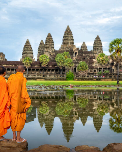 Asian monk stand and look to Angkor wat in siem reap Asian monk stand and look to Angkor wat in siem reap