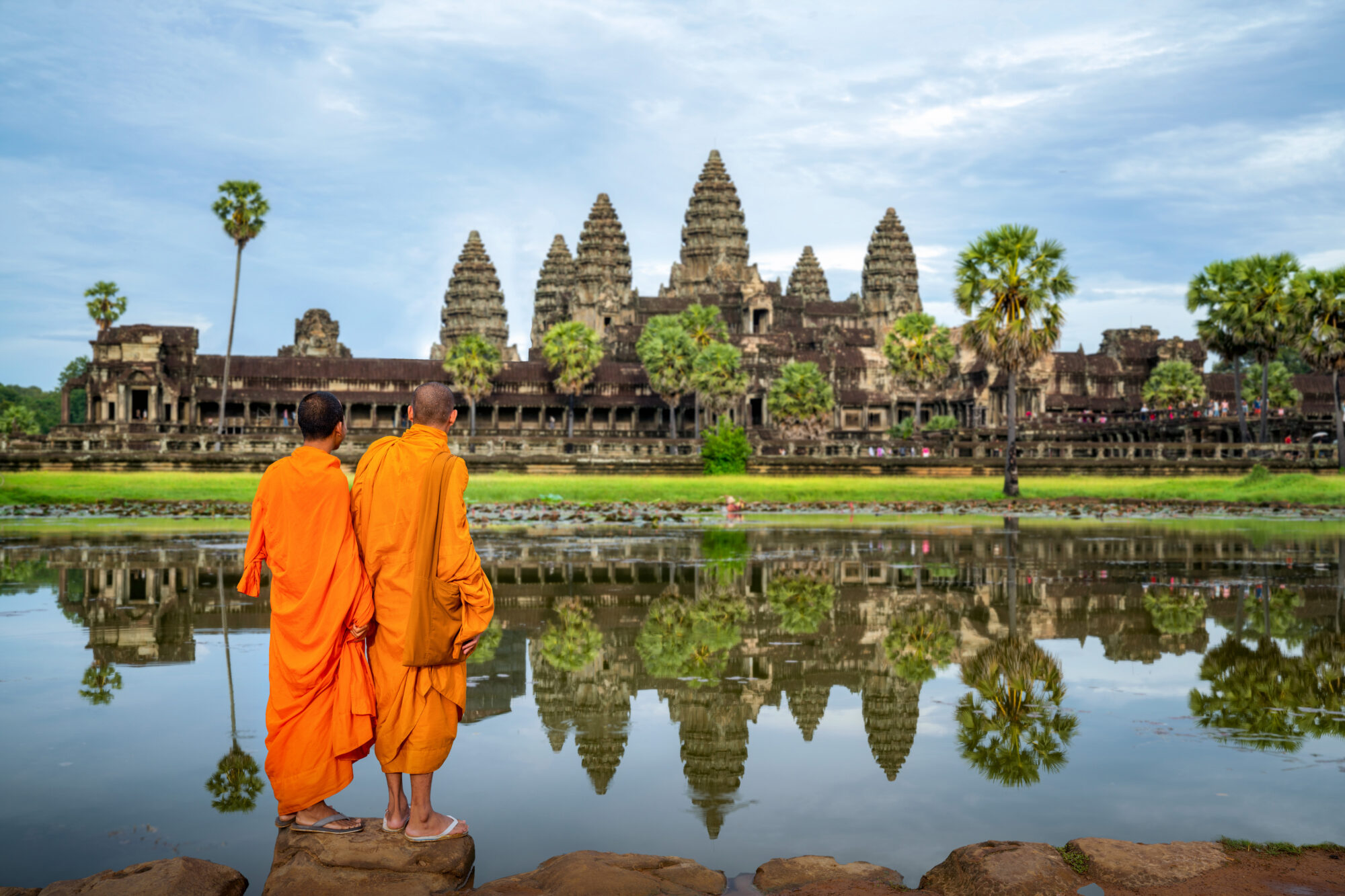 Asian monk stand and look to Angkor wat in siem reap Asian monk stand and look to Angkor wat in siem reap