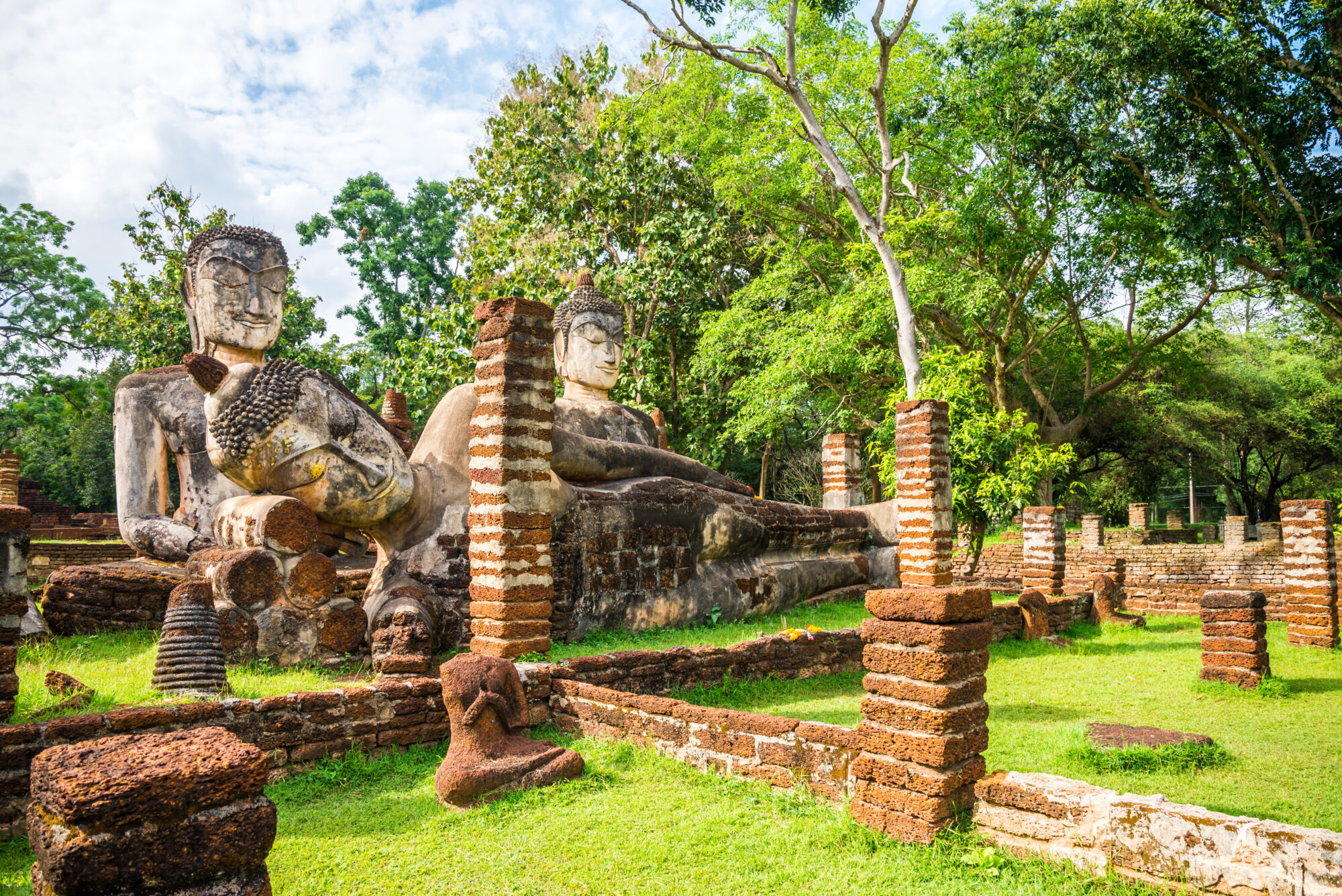 Big three antique sitting and sleeping buddha in world heritage Kamphaeng Phet historical park, Thailand. Wat phra kaew temple.