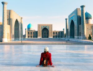 Tourist,Woman,With,Hat,And,Dress,Red,Sitting,On,Registan, Tourist,Woman,With,Hat,And,Dress,Red,Sitting,On,Registan,